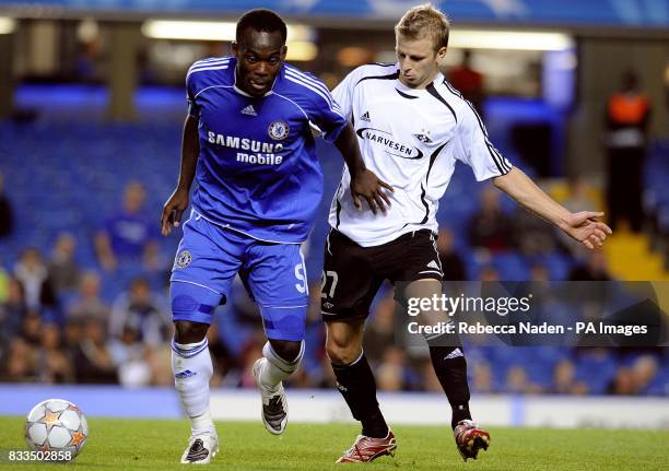 Chelsea's Michael Essien and Rosenborg's Marek Sapara battle for the ball.