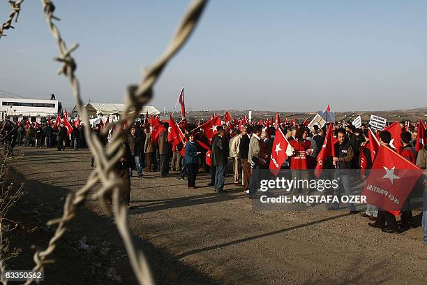 Supporters of a shadowy armed group, Ergenekon, that plotted to overthrow the country's Islamist-rooted government, chant slogans and wave Turkish...