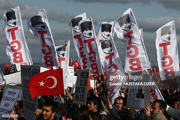 Supporters of a shadowy armed group, Ergenekon, that plotted to overthrow the country's Islamist-rooted government, chant slogans and wave Turkish...