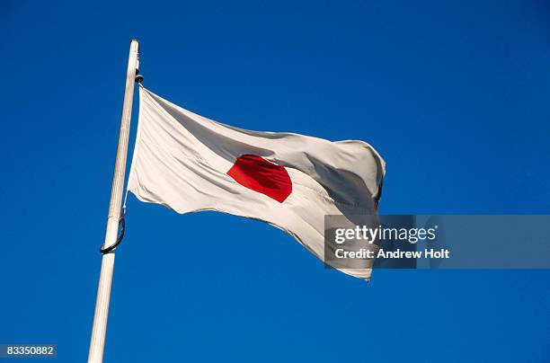 the red sun japanese nationa flag of japan in wind - japanische flagge stock-fotos und bilder