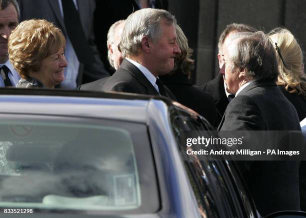 Jimmy McRae with his wife Margaret with Sir Jacke Stewart arriving for the funeral of Colin McRae and son Johnny at East Chapel, Daldowie Crematorium.