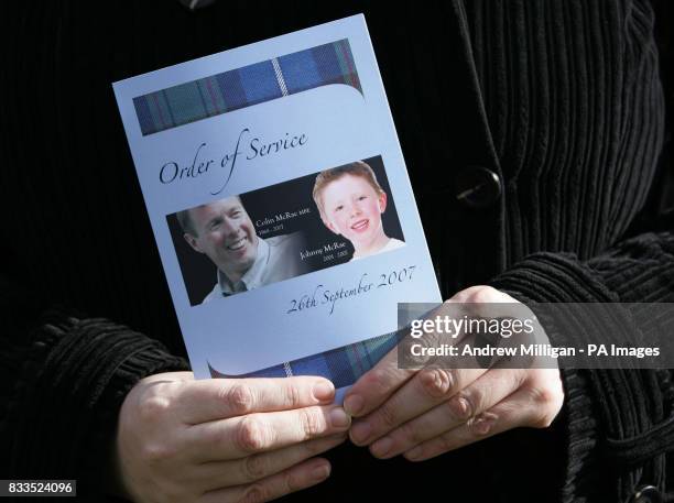 Mourner holds the order of service for the funeral of Colin McRae and his son Johnny outside at East Chapel, Daldowie Crematorium.