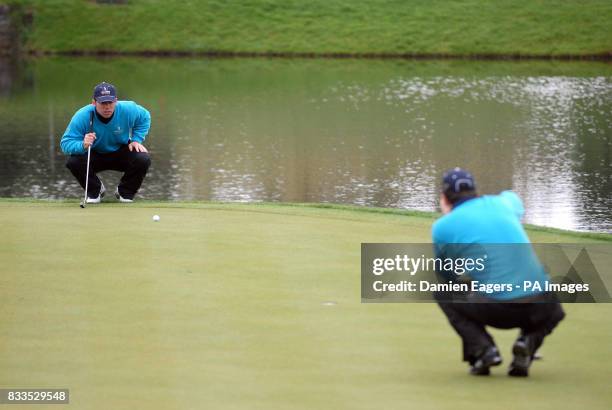 Great Britain and Ireland's Paul Casey and Justin Rose line a putt up on the 17th green during the Greensomes during day three of the Seve Trophy at...