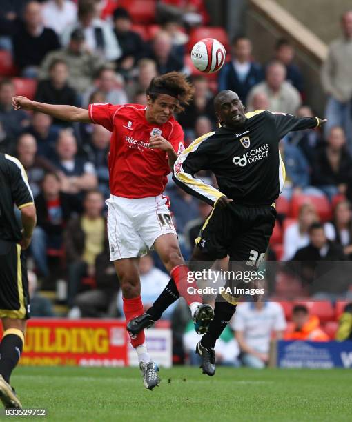 Cardiff City's Jimmy Floyd Hasselbaink and Barnsley's Dennis Souza during the Coca-Cola Football League Championship match at the Oakwell Ground,...