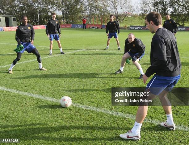 Anderson, Manucho, Wayne Rooney and Darren Fletcher of Manchester United take part in a First Team Training Session at Carrington Training Ground on...