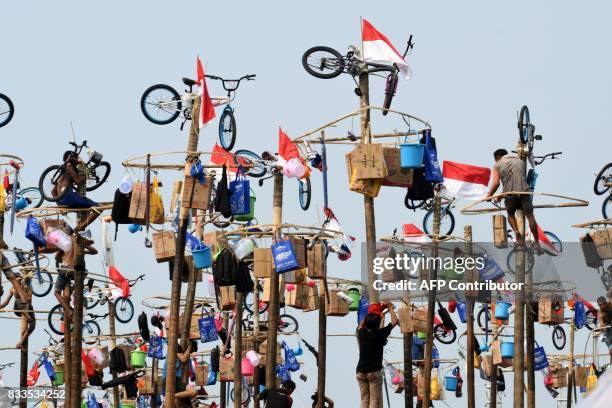 Participants take part in Panjat Pinang, a pole climbing contest, as part of festivities marking Indonesia's 72nd Independence Day on Ancol beach in...