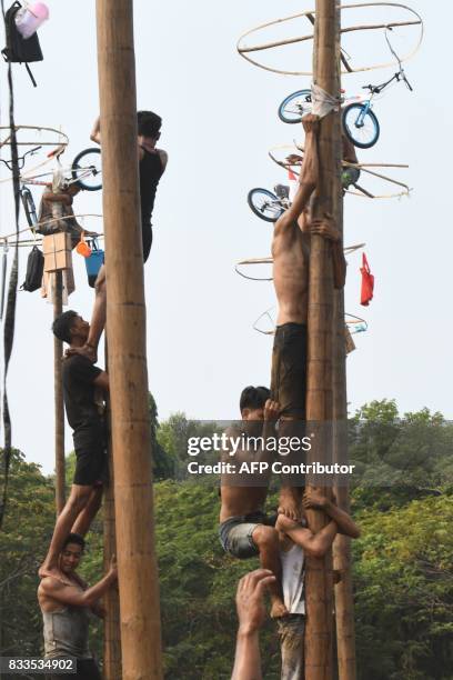 Participants take part in Panjat Pinang, a pole climbing contest, as part of festivities marking Indonesia's 72nd Independence Day on Ancol beach in...