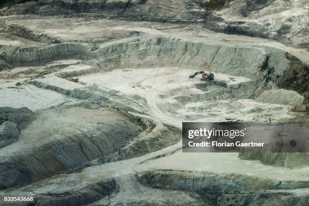 This aerial photo shows an excavator in the middle of a gravel pit on August 04, 2017 in Kamenz, Germany..