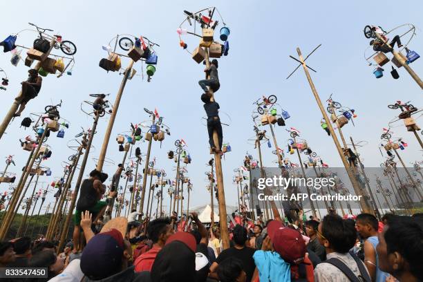 Participants take part in Panjat Pinang, a pole climbing contest, as part of festivities marking Indonesia's 72nd Independence Day on Ancol beach in...