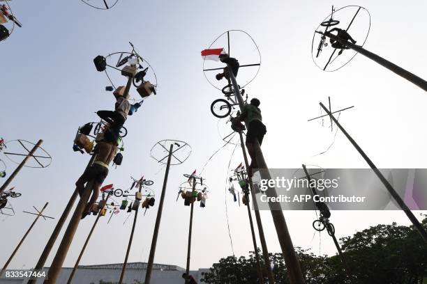 Participants take part in Panjat Pinang, a pole climbing contest, as part of festivities marking Indonesia's 72nd Independence Day on Ancol beach in...