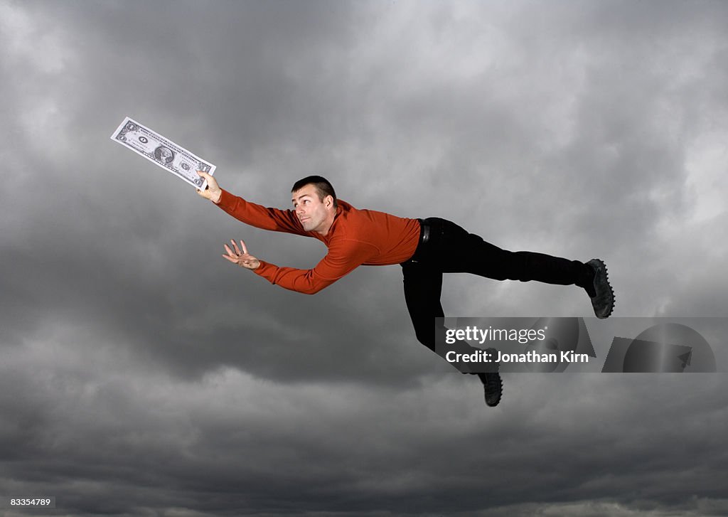 Man jumping against cloudy sky