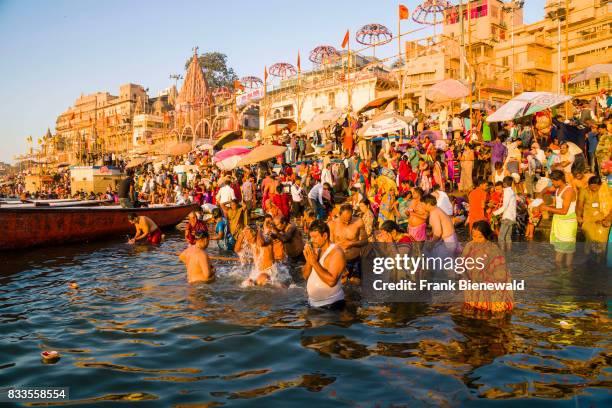 Pilgrims are taking bath in the holy river Ganges at Dashashwamedh Ghat, Main Ghat, in the suburb Godowlia.