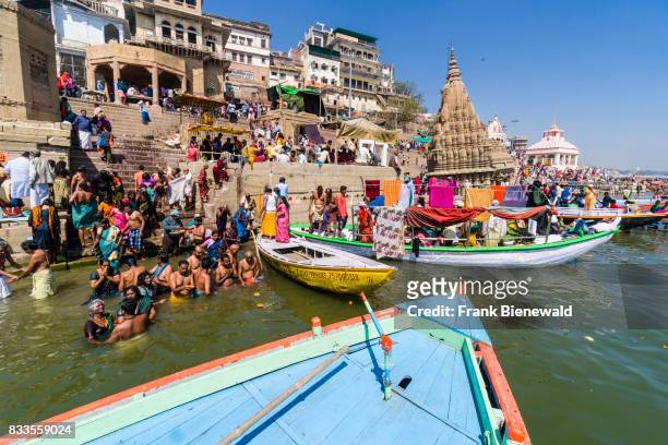 Pilgrims are taking bath in the holy river Ganges at Manikarnika Ghat in the suburb Godowlia.