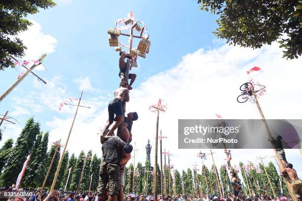 Indonesians celebrate their 72nd independence day by doing greased pole climbing competition to win some prizes include motorcycle, in Renon Park,...