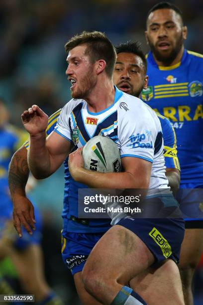 Joe Greenwood of the Titans is tackled during the round 24 NRL match between the Parramatta Eels and the Gold Coast Titans at ANZ Stadium on August...