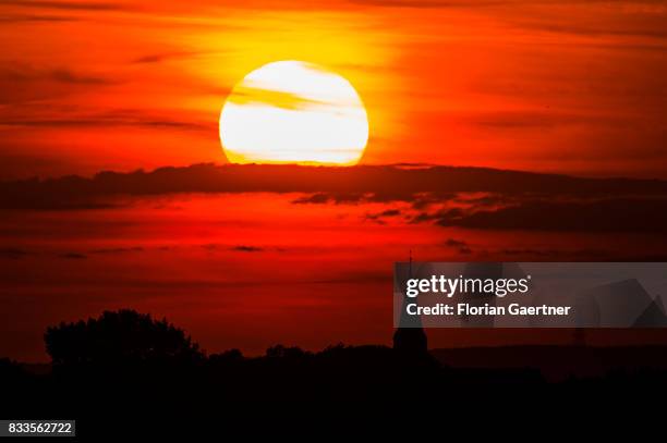 The sun sets behind the church Marienkirche on August 14, 2017 in Salzwedel, Germany..