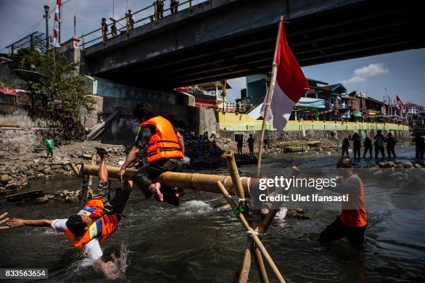 Indonesian men take part in pillow fighting competition during celebrations for the 72nd Indonesia National Independence day at Code river on August...