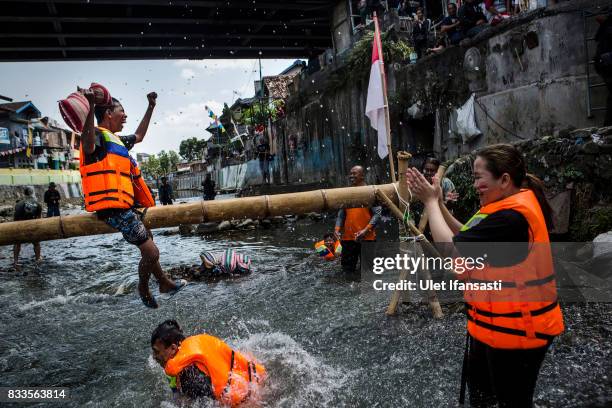 Indonesian men take part in pillow fighting competition during celebrations for the 72nd Indonesia National Independence day at Code river on August...