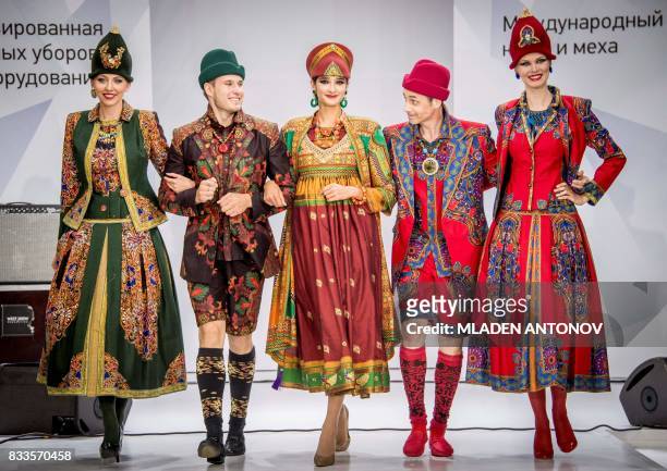 Models display creations by legendary Soviet-Russian designer Slava Zaitsev during a fashion show in Moscow on August 17, 2017.