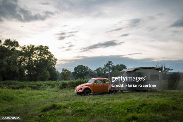 An old VW Kaefer with a caravan stands near the river Elbe on August 15, 2017 in Havelberg, Germany.