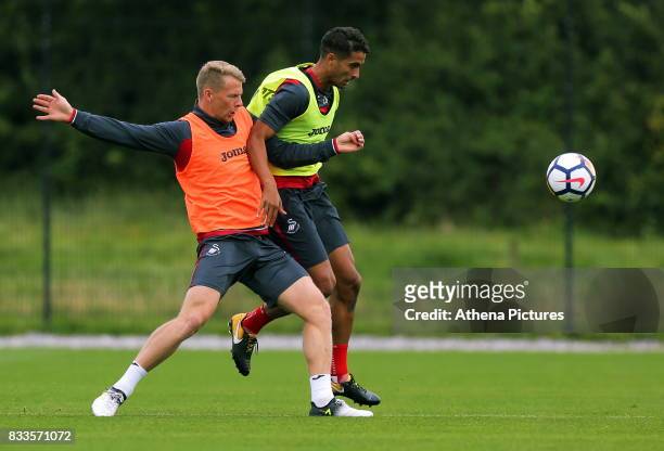 Kyle Naughton challenged by Stephen Kingsley during the Swansea City Training at The Fairwood Training Ground on August 16, 2017 in Swansea, Wales.