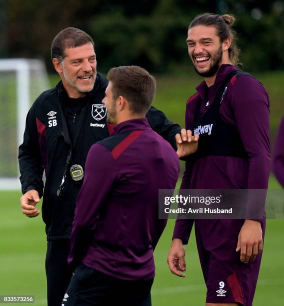 Manager Slaven Bilic of West Ham United tells a story to Andy Carroll and Aaron Cresswell prior to training at Rush Green on August 17, 2017 in...