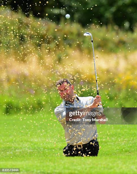 Mark Hancock of Stand Golf Club chips out of a bunker on the 18th green during the Golfbreaks.com PGA Fourball Championship - Day 2 at Whittlebury...