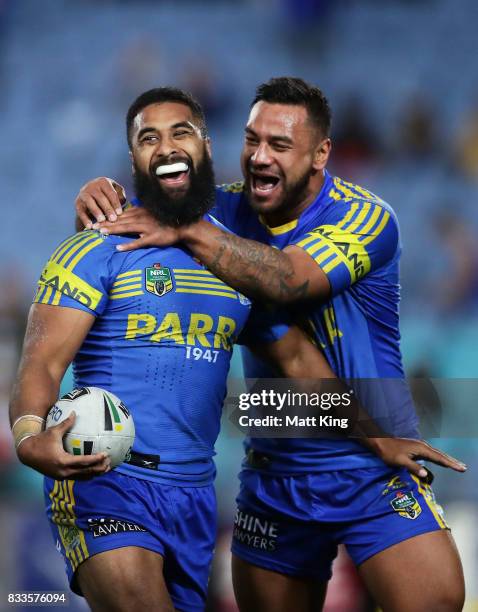 Michael Jennings of the Eels celebrates with Kenny Edwards after scoring a try that was subsequently disallowed during the round 24 NRL match between...