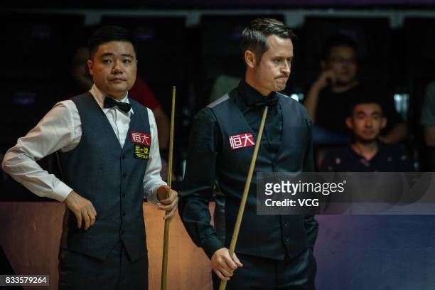 Ding Junhui of China and Alfie Burden of England look on during their first round match on day two of Evergrande 2017 World Snooker China Champion at...