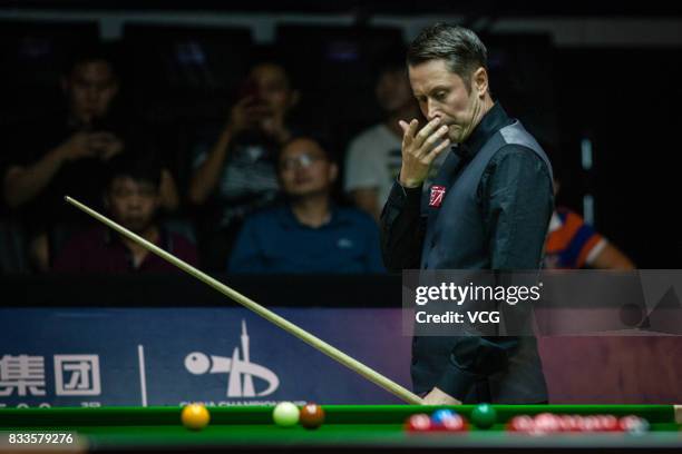 Alfie Burden of England reacts during his first round match against Ding Junhui of China on day two of Evergrande 2017 World Snooker China Champion...