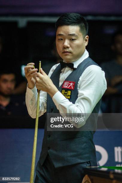 Ding Junhui of China chalks the cue during his first round match against Alfie Burden of England on day two of Evergrande 2017 World Snooker China...