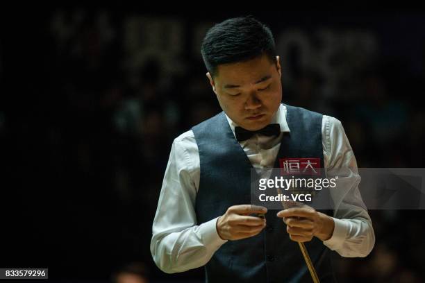 Ding Junhui of China chalks the cue during his first round match against Alfie Burden of England on day two of Evergrande 2017 World Snooker China...