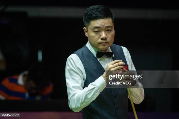 Ding Junhui of China chalks the cue during his first round match against Alfie Burden of England on day two of Evergrande 2017 World Snooker China...