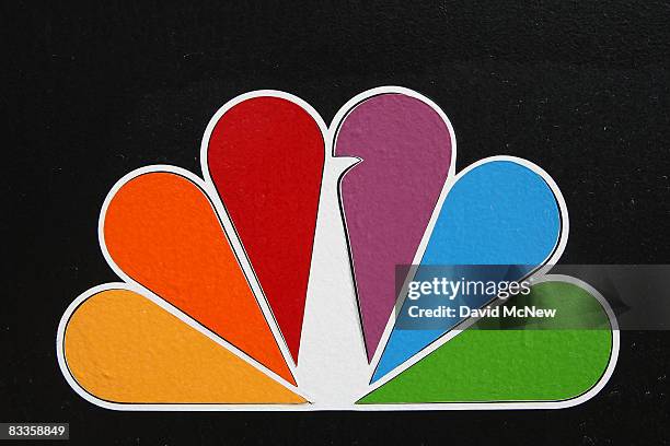 The NBC peacock logo hangs on the NBC studios building on October 20, 2008 in Burbank, California. NBC Universal plans another round of major cuts...