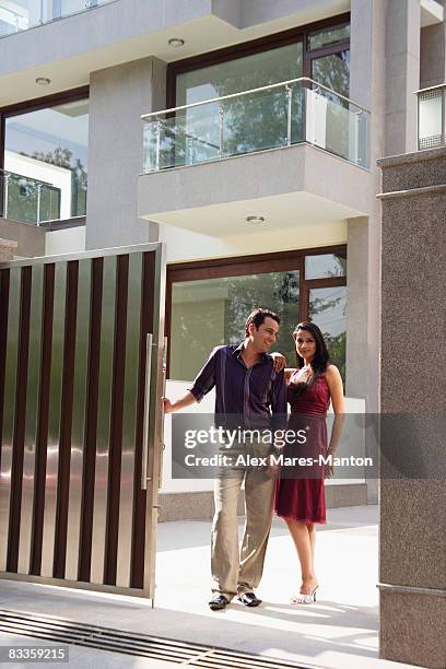 young couple standing at the gate - stereotypically upper class stock pictures, royalty-free photos & images