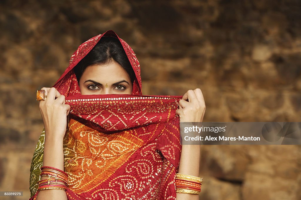 Woman with sari covering face
