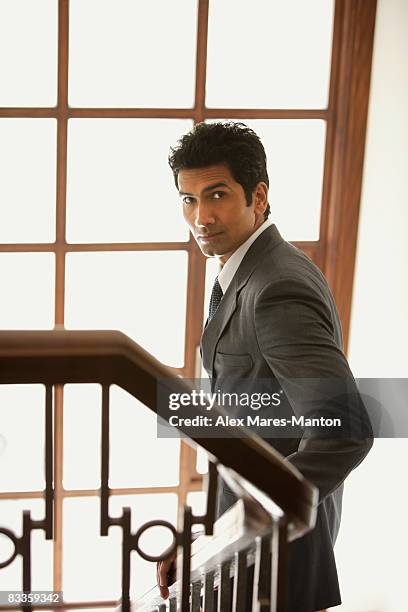 businessman walking down stairs - pensive indian man stock pictures, royalty-free photos & images