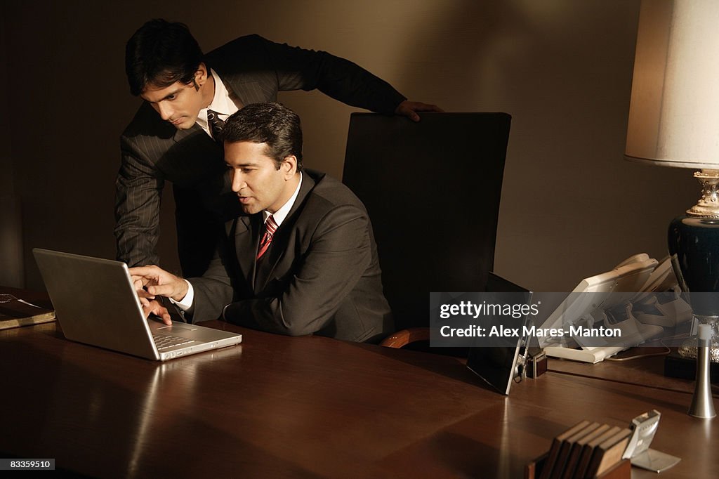 Business associates at laptop computer