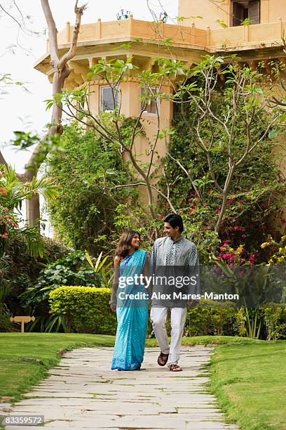 young couple in garden - hedge fonds stock pictures, royalty-free photos & images