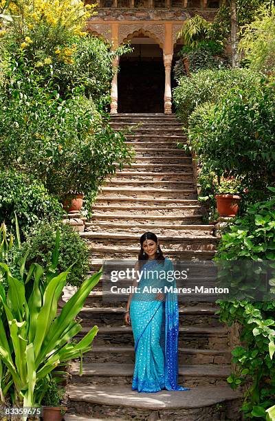 young woman in sari, on steps - portrait of young woman standing against steps imagens e fotografias de stock