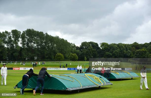 Dublin , Ireland - 17 August 2017; Players leave the field and rain covers are put on the crease as play is halted due to rain during the ICC...