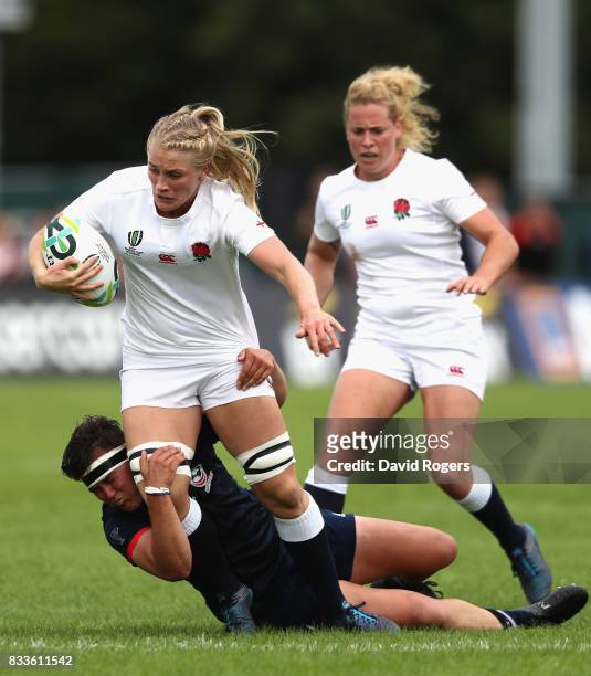 Alex Matthew of England is tackled by Sara Parsons of USA during the Women's Rugby World Cup Pool B match between England and USA at Billings Park...