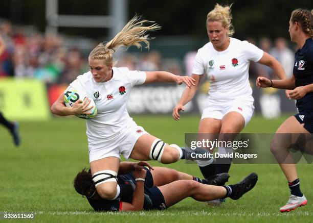 Alex Matthew of England is tackled by Sara Parsons of USA during the Women's Rugby World Cup Pool B match between England and USA at Billings Park...