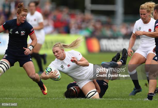 Alex Matthew of England is tackled by Sara Parsons of USA during the Women's Rugby World Cup Pool B match between England and USA at Billings Park...