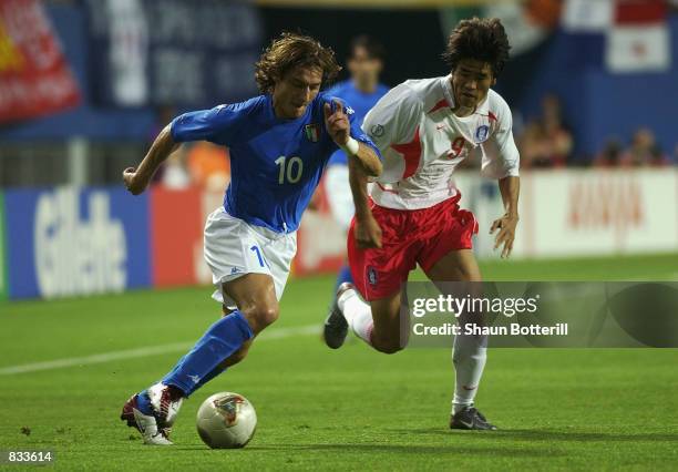 Francesco Totti of Italy takes the ball past Ki Hyeon Seol of South Korea during the FIFA World Cup Finals 2002 Second Round match played at the...