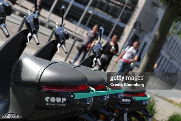 Row of Coup eScooter electric hire vehicles, operated by Robert Bosch GmbH, stand in Berlin, Germany, on Thursday, Aug. 17, 2017. Coup is one of...