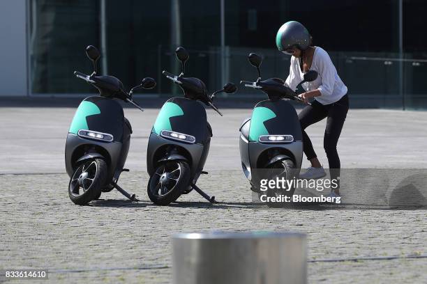 An employee mounts a Coup eScooter electric hire vehicle, operated by Robert Bosch GmbH, in Berlin, Germany, on Thursday, Aug. 17, 2017. Coup is one...