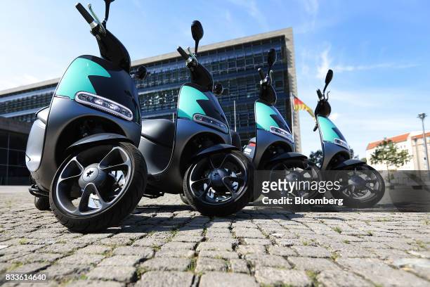 Row of Coup eScooter electric hire vehicles, operated by Robert Bosch GmbH, stand in Berlin, Germany, on Thursday, Aug. 17, 2017. Coup is one of...