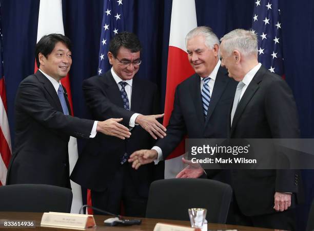 Secretary of State Rex Tillerson , Defense Secretary James Mattis , shake hands with Japanese Foreign Minister Taro Kono and Defense Minister...