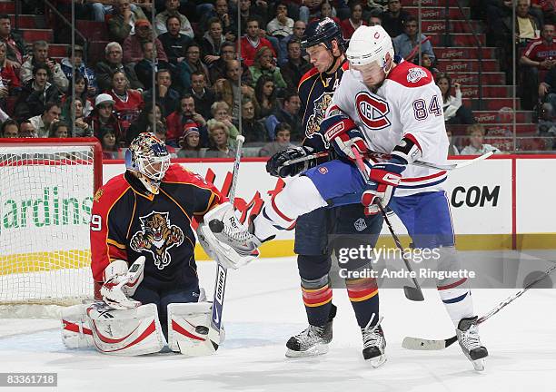 Tomas Vokoun of the Florida Panthers makes a save against a screen attempt by Guillaume Latendresse of the Montreal Canadiens on a power play as...